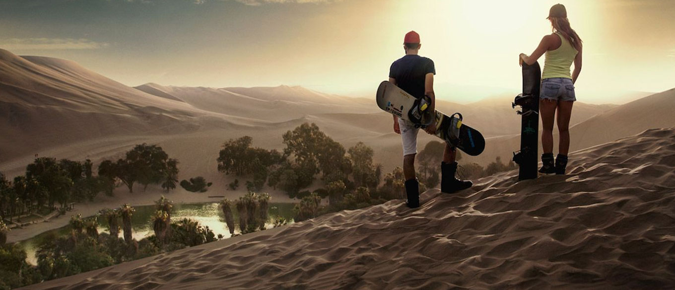 Sandboarders on Huacachina's sand dunes.