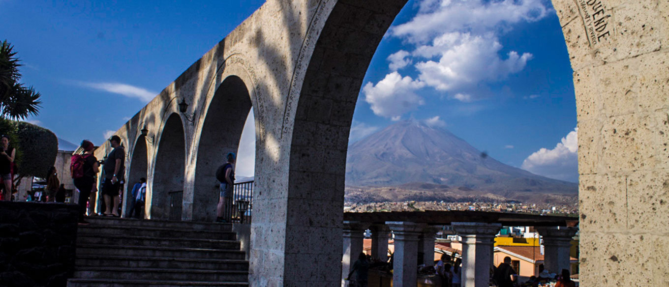 View of volcano through stone arches in Arequipa, Peru.