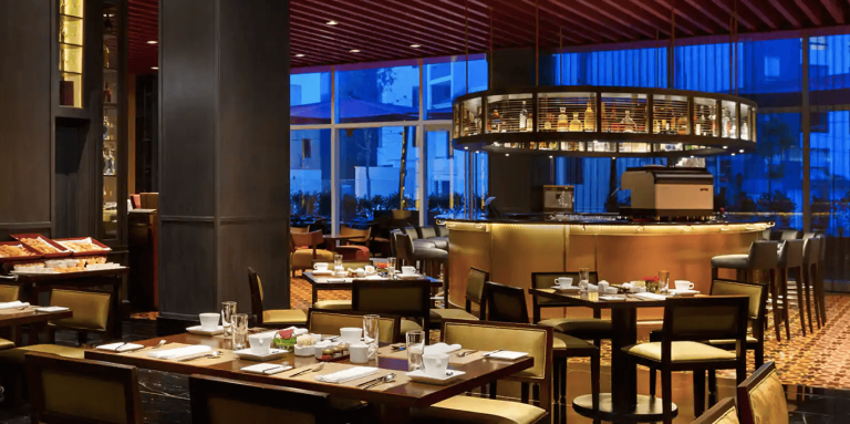 Elegant dining area with tables and modern bar at Hilton Lima Miraflores.