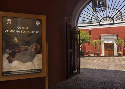 Entrance of the Santuario San Andrés Museum with a poster and a courtyard view.