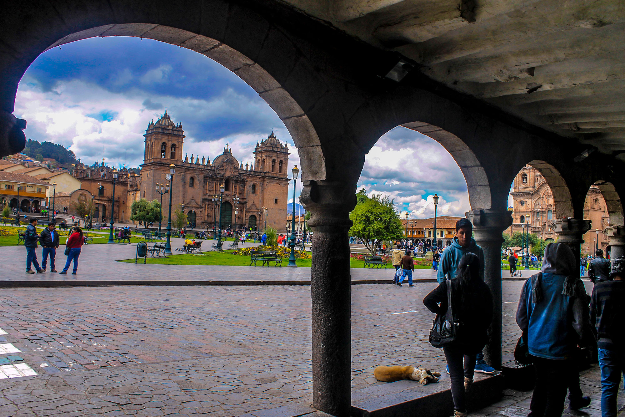 Plaza de Armas of Cusco with colonial buildings and mountains.